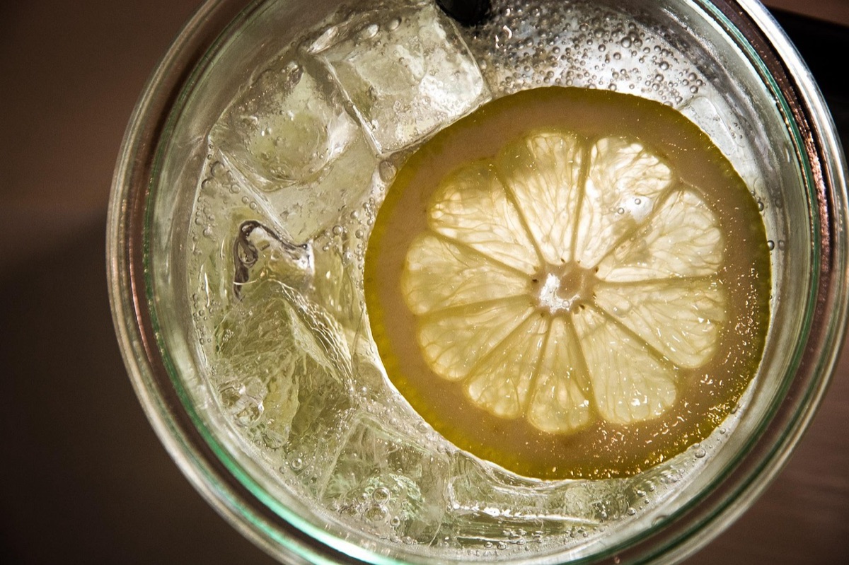 Strawberry in glass with ice and lemon slice